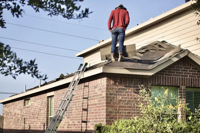 Professional roofer working on a residential roof in Bynum